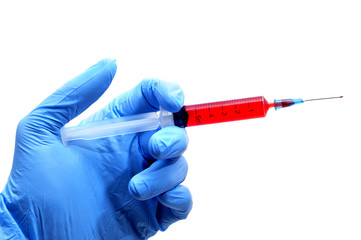 someone wearing medical gloves holding a syringe
