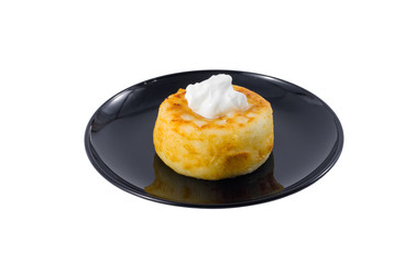 Fried quark cheese pancake with sour cream on the top.