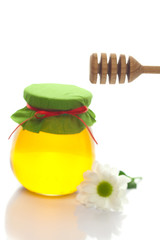 stick to hohey ,flower  and  jar of honey  isolated on white