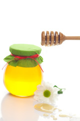 stick to hohey ,flower  and  jar of honey  isolated on white