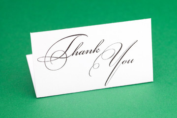 card signed thank you on green background