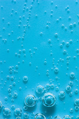 Blue abstract water with bubbles. Macro. Closeup. Vertical.
