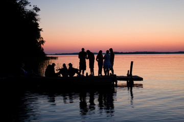 Silhouette of friends on dock