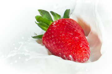 strawberry splashing into milk