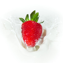 strawberry splashing into milk