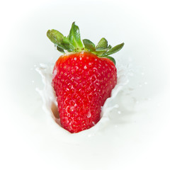 strawberry splashing into milk