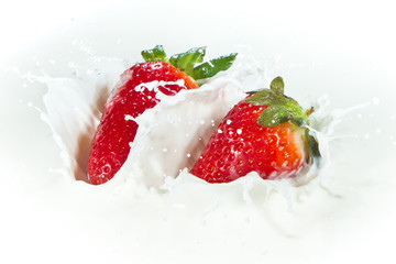 strawberry splashing into milk