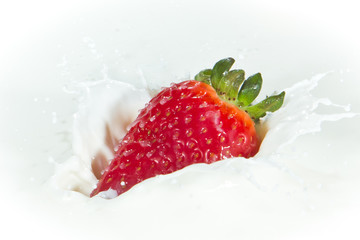 strawberry splashing into milk