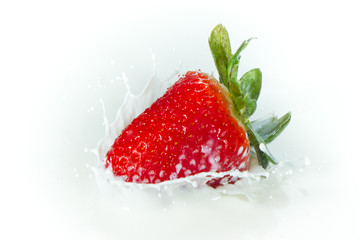 strawberry splashing into milk