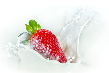 strawberry splashing into milk