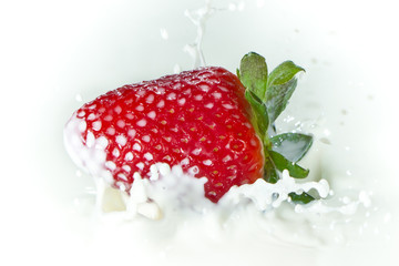 strawberry splashing into milk