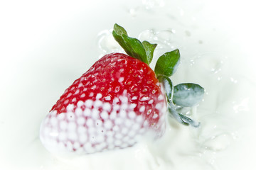 strawberry splashing into milk
