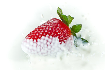 strawberry splashing into milk
