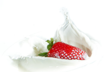 strawberry splashing into milk