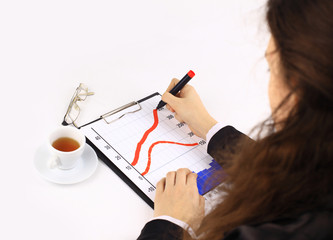 Closeup of business lady’s hand with pen signing a