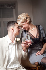 Happy bride and groom in bedroom interior