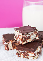 Chocolate cakes with glass of milk and pink background