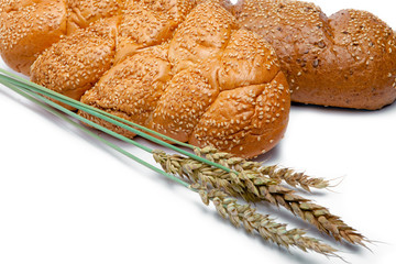 Wheat and bread on white background