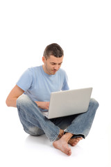 handsome young male study on laptop computer. isolated