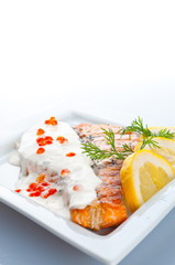 Steak from a salmon with creamy sauce and caviar..