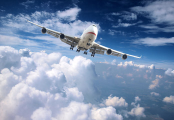 Big jet airplane flying above clouds