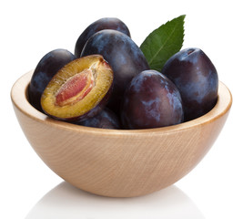 fresh plums in bowl isolated