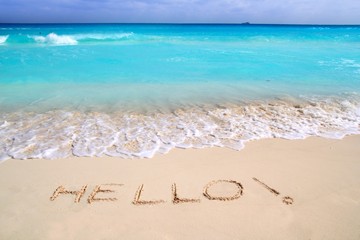 Hello message spell written in tropical beach sand
