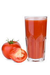 Drinking glass filled with tomato juice and tomatoes near