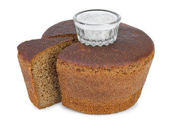 Cut loaf of round rye bread and salt jar