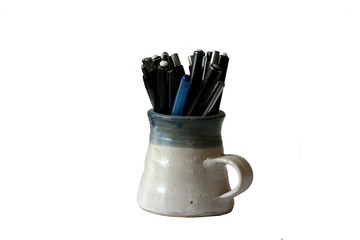 Rustic mug with pens and mechanical pencils