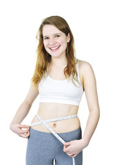 Happy young girl measuring her waist