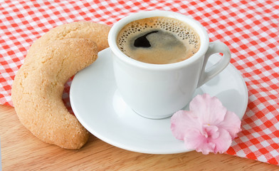 Cup of coffee with a batch on a cloth