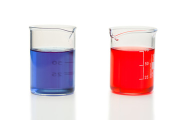 Red and blue liquid in beakers