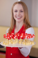 verkäuferin mit schweizer käse zum probieren