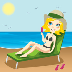 Attractive blond woman on a chaise lounge sunbathing