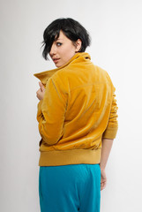 Beautiful brunette girl with yellow jeans jacket and turquoise p