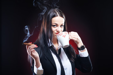 Beautiful elegant young woman with cigar and cup of coffee