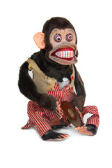 Damaged mechanical chimp with ripped vest, uneven eyes