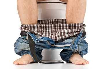 man is sitting on toilet