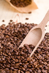 coffee beans on wooden scoop