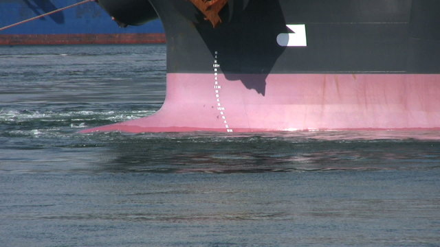 Ship Being Tugged Through Harbor