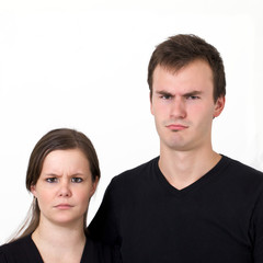 Husband and wife looking serous with frowns