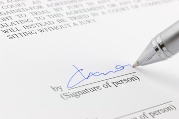 Signature under a business contract with pen