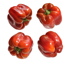 Four red peppers isolated on white