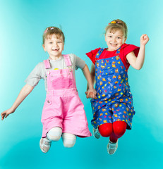 Twin sisters jumping