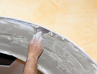 Men at work spreading plaster