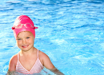 Child swimming in pool.