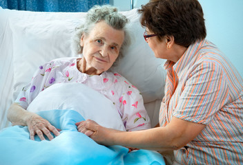 Senior female is being visited by the daughter in hospital