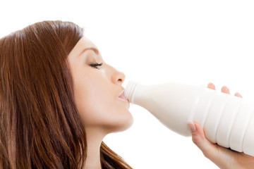 Young woman drinking milk, isolated on white background