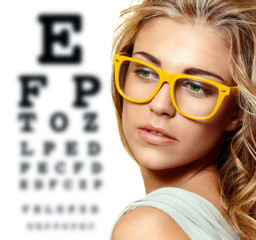 eye test chart and woman in glasses